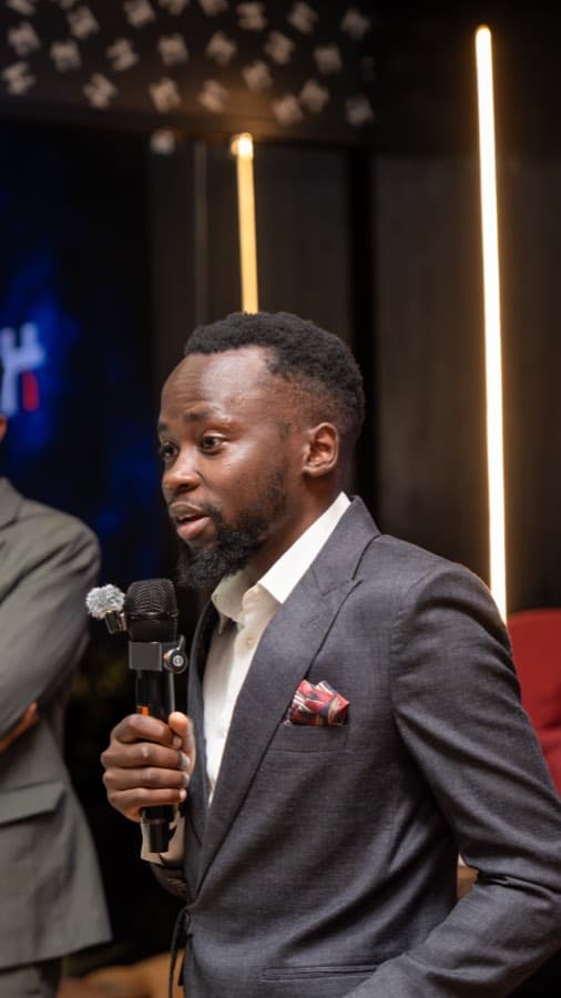 Magothe Innocent speaking on stage
